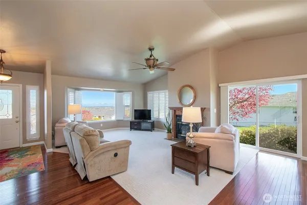 a living room with fireplace furniture and a wooden floor