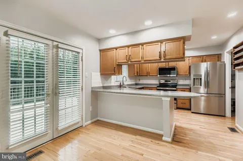a kitchen with stainless steel appliances a refrigerator and a stove top oven
