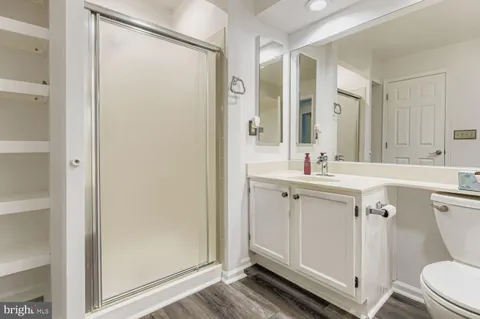 a bathroom with a sink mirror vanity and toilet