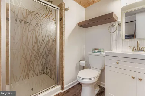 a bathroom with a toilet sink and shower