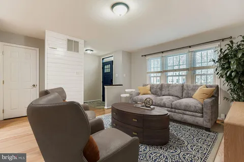 a living room with furniture potted plant and a window