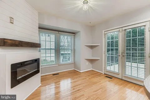 a view of an empty room with a fireplace and a window