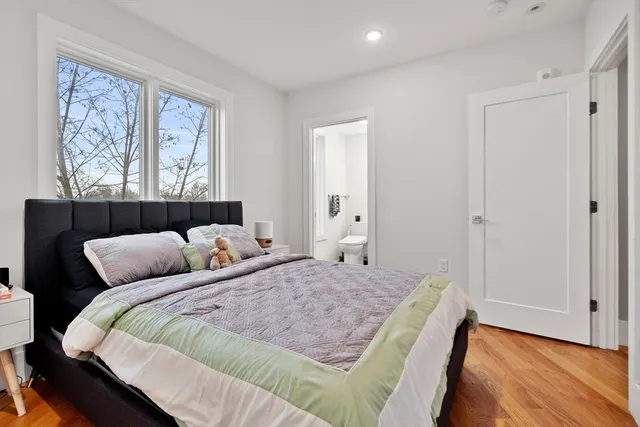 a bedroom with a bed and wooden floor