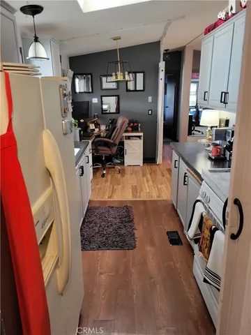 a close view of a sink a stove and a wooden floor