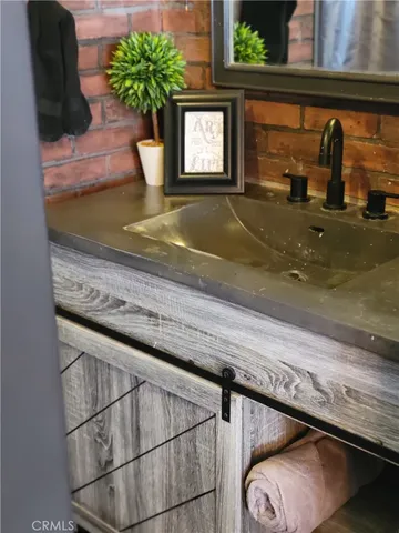 a bedroom with a bed and a mirror on the dresser