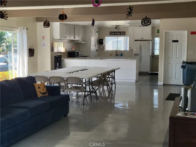 a view of a patio with furniture and table under an umbrella