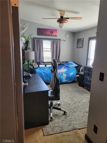 a bedroom with bed and a window