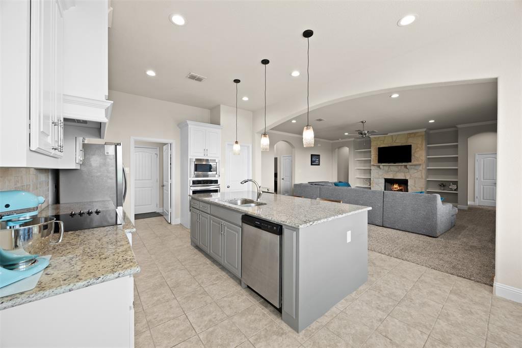 2618 Byrd Ranch Road Midlothian, TX 76065 - Photo 16 of 38 a kitchen with stainless steel appliances granite countertop a sink and a refrigerator