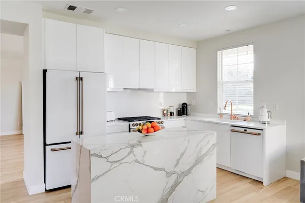 a kitchen with cabinets and steel stainless steel appliances