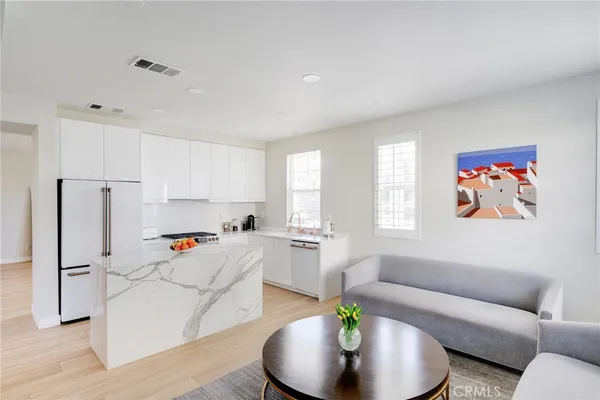 a kitchen with a refrigerator a sink a stove and a window