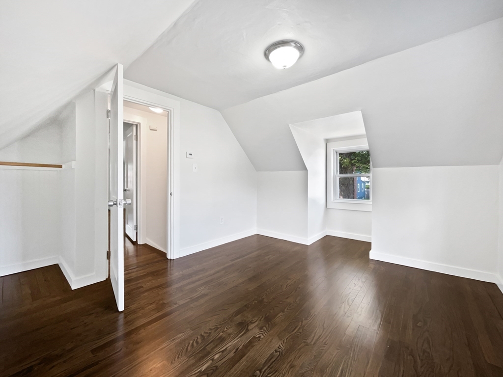 444 Lowell Street Reading, MA 01867 - Photo 16 of 38 an empty room with wooden floor and windows