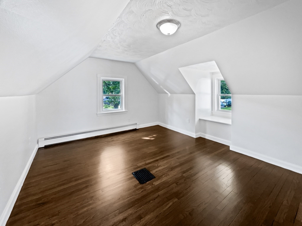 444 Lowell Street Reading, MA 01867 - Photo 20 of 38 an empty room with wooden floor and window