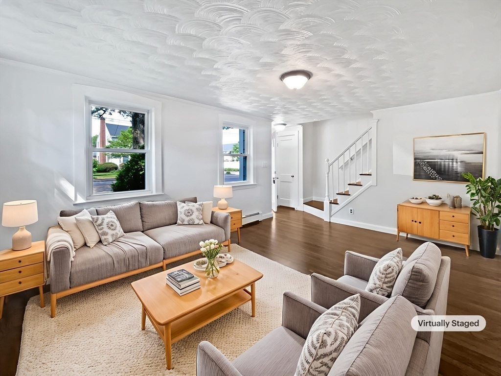 444 Lowell Street Reading, MA 01867 - Photo 2 of 38 a living room with furniture and a large window