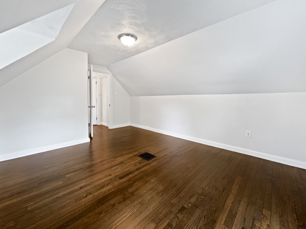 444 Lowell Street Reading, MA 01867 - Photo 23 of 38 a view of an empty room with wooden floor