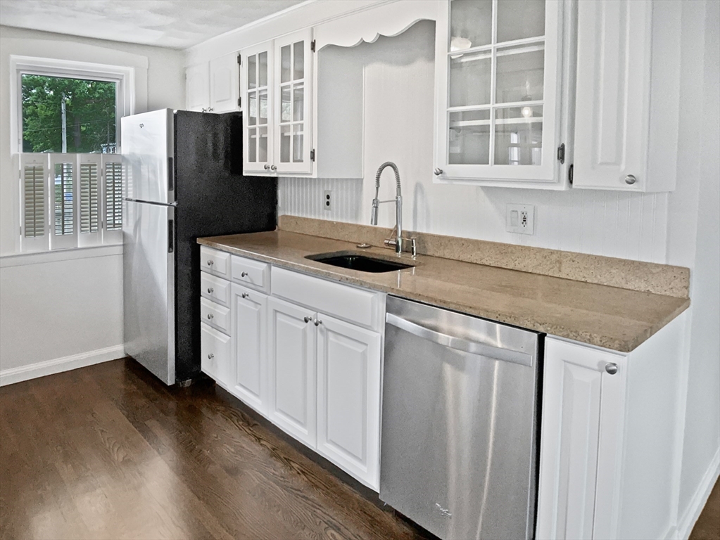 444 Lowell Street Reading, MA 01867 - Photo 25 of 38 a kitchen with stainless steel appliances granite countertop a refrigerator and a sink