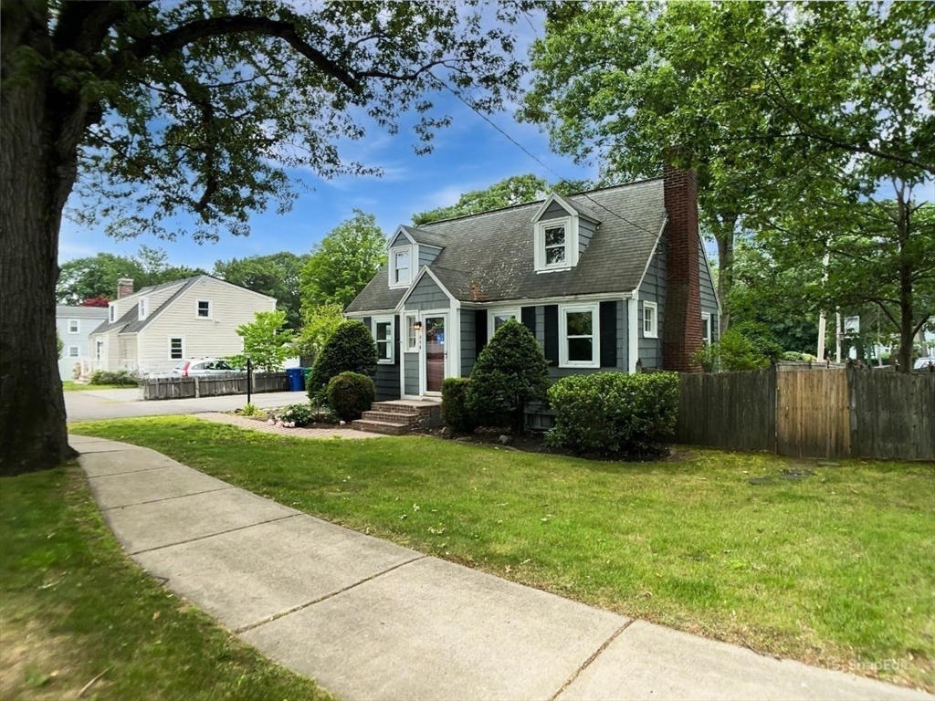 444 Lowell Street Reading, MA 01867 - Photo 32 of 38 a front view of a house with garden