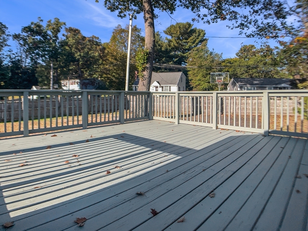 444 Lowell Street Reading, MA 01867 - Photo 33 of 38 a view of deck with wooden floor and fence and floor to ceiling window