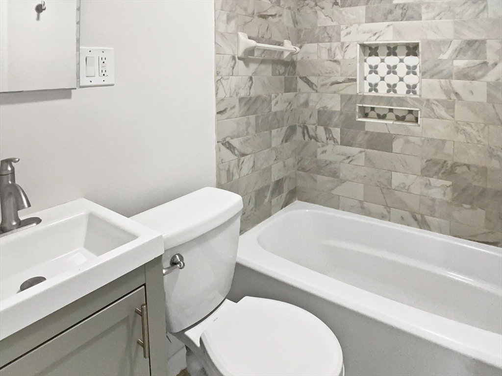 444 Lowell Street Reading, MA 01867 - Photo 7 of 38 a bathroom with a sink and a toilet