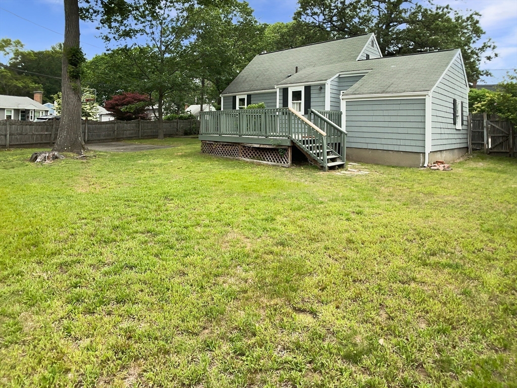 444 Lowell Street Reading, MA 01867 - Photo 8 of 38 a view of a house with a yard and sitting area