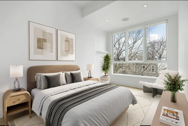 a bedroom with a large bed and a large window