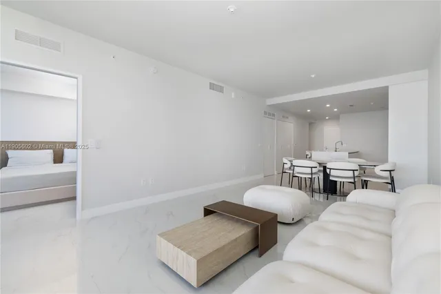 a spacious bedroom with a large bed and a large window