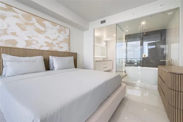 a bedroom with a large bed and a couch