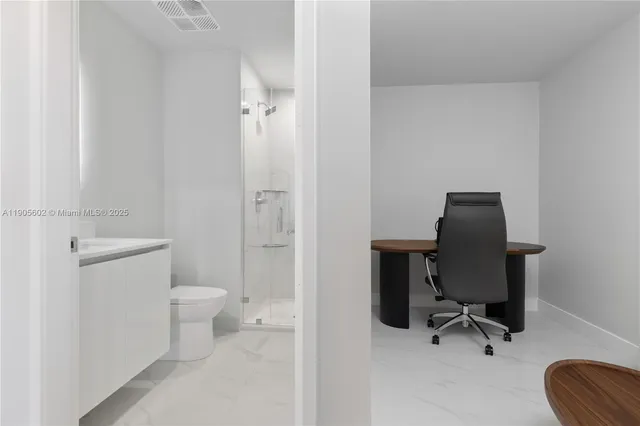 a living room with furniture and a walk in closet