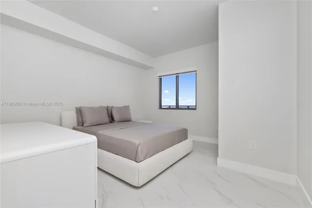 a large white bed in a white room