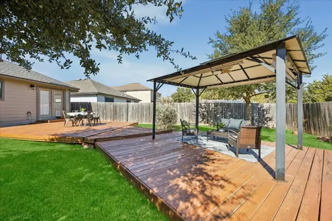 a view of a patio with a table chairs and a backyard