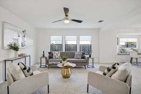 a living room with furniture and a large window