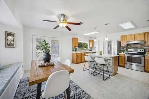 a living room with furniture and kitchen view
