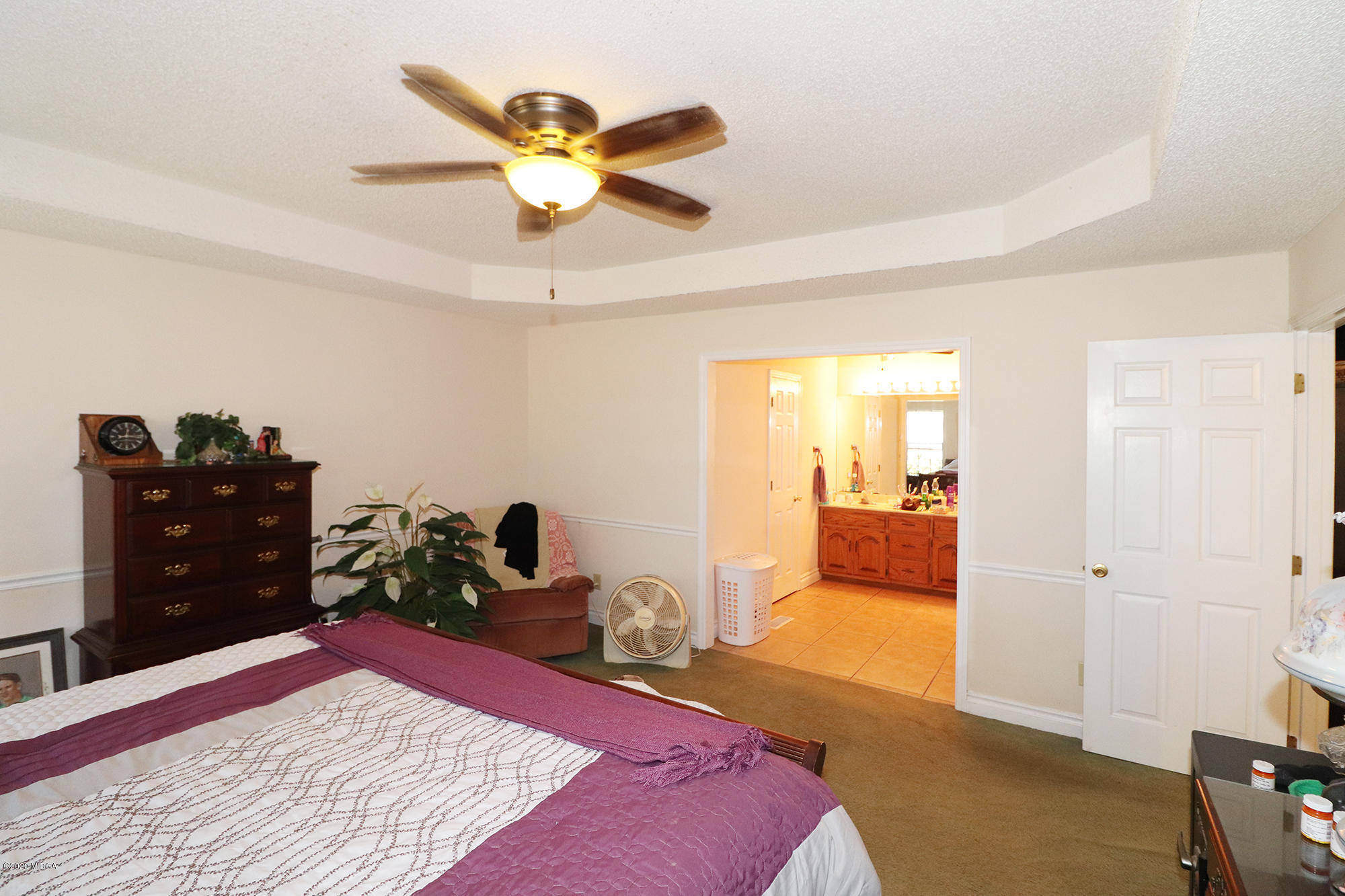 48 Grace Road Knoxville, GA 31050 - Photo 18 of 62 a bed room with a bed and a chandelier