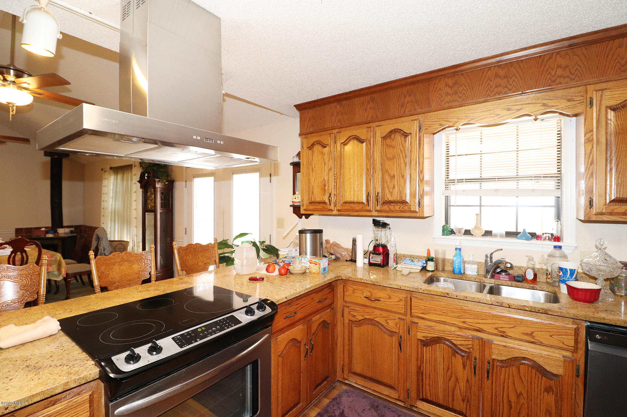 48 Grace Road Knoxville, GA 31050 - Photo 4 of 62 a kitchen with a stove a sink cabinets and a window