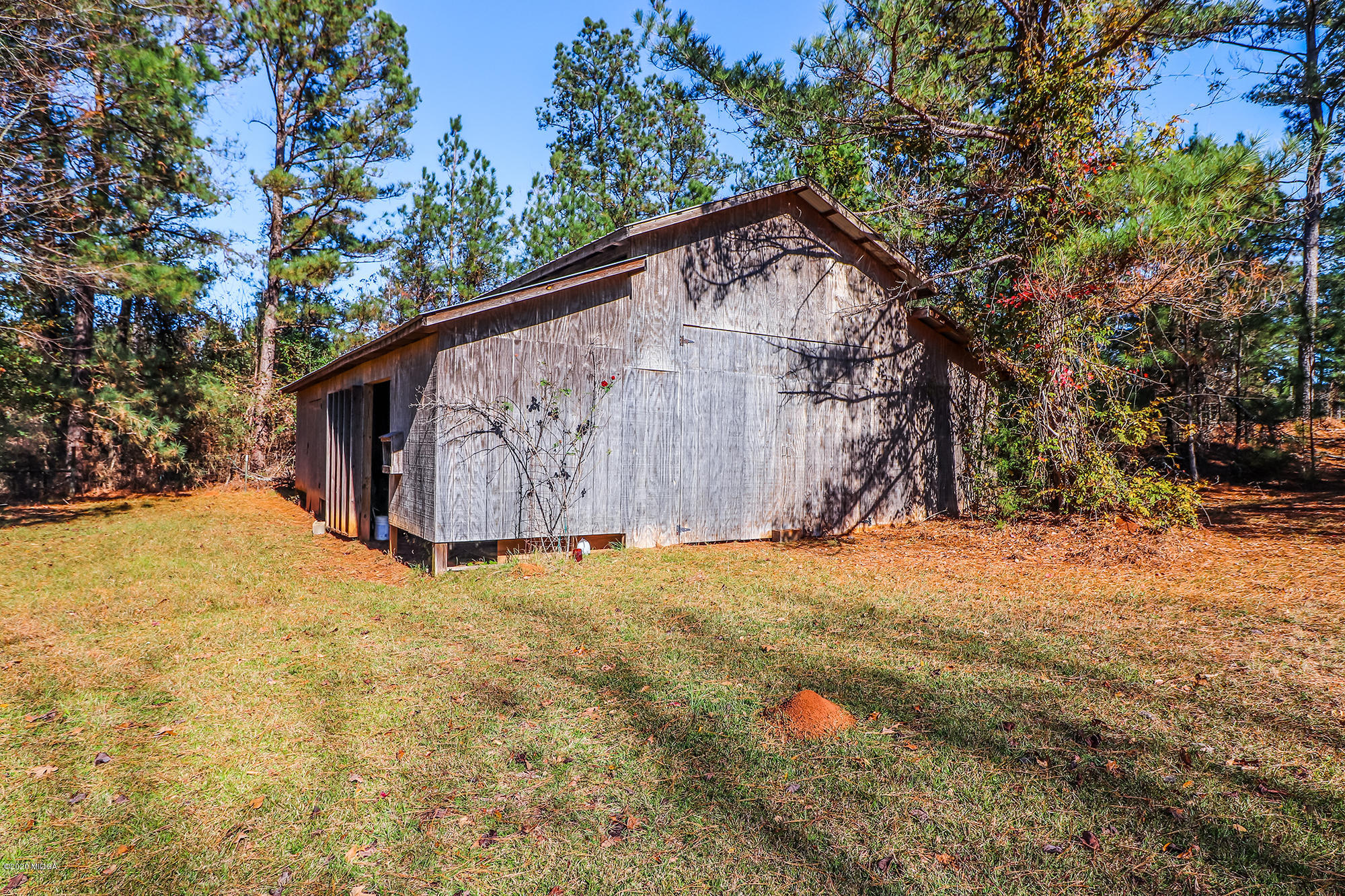 48 Grace Road Knoxville, GA 31050 - Photo 46 of 62 a backyard of a house with large trees and wooden fence
