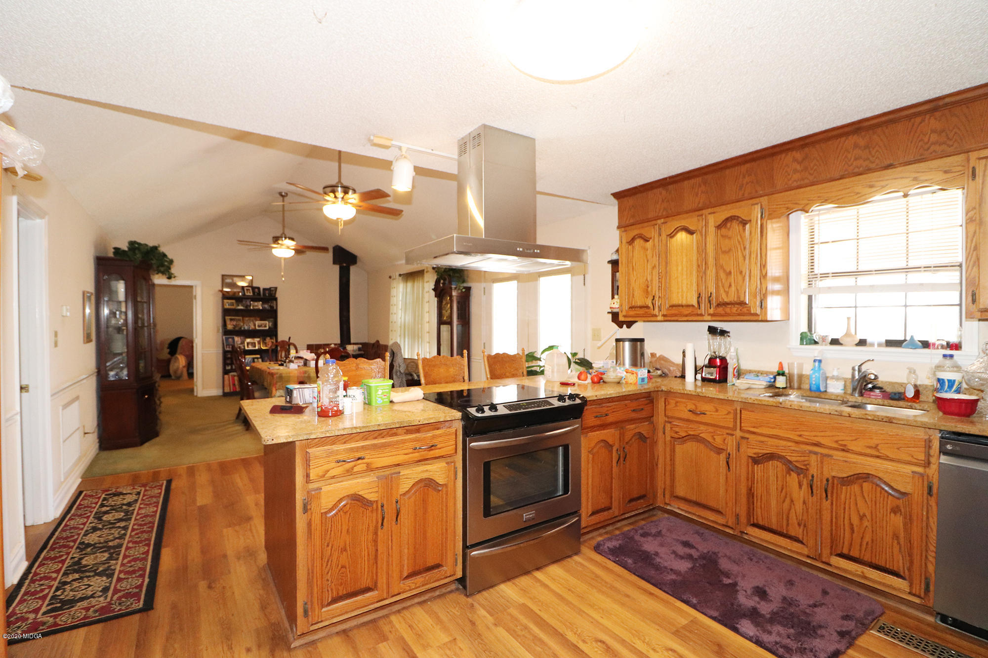 48 Grace Road Knoxville, GA 31050 - Photo 6 of 62 a kitchen with stainless steel appliances granite countertop a sink stove and refrigerator