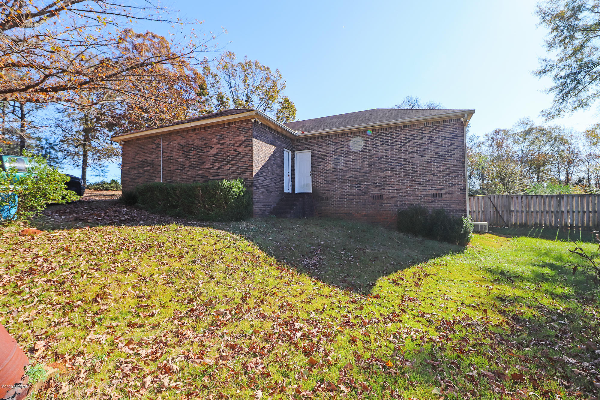 48 Grace Road Knoxville, GA 31050 - Photo 62 of 62 a view of a backyard with brick wall and potted plants