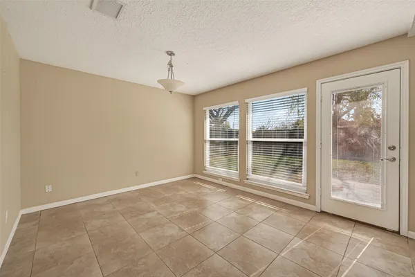 a view of wooden floor and windows in a room