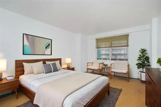 a bedroom with furniture and a window