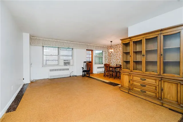 an empty room with furniture and windows