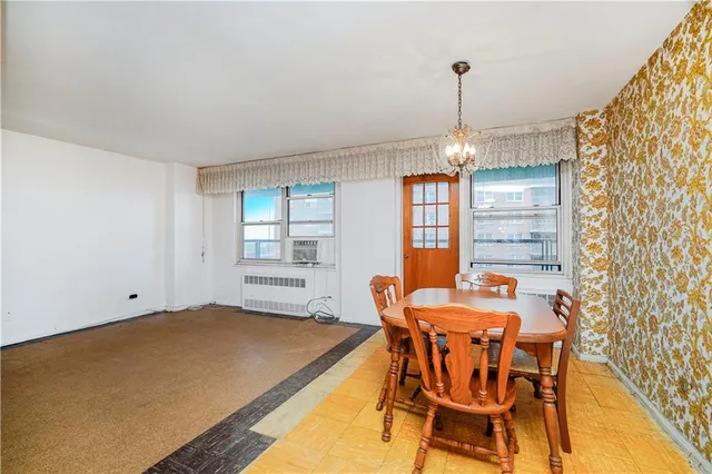 a dining room with a table chairs and a chandelier