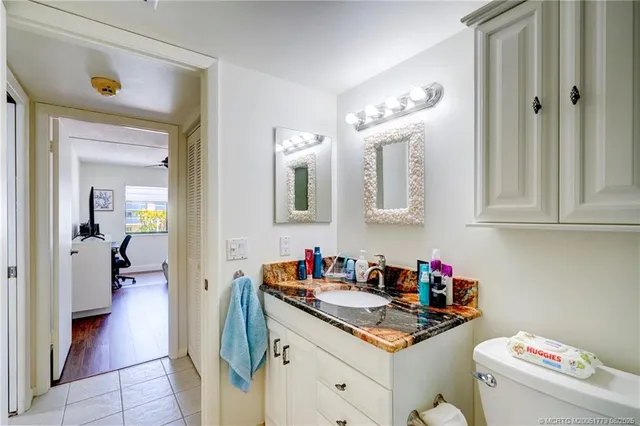 a kitchen with a sink cabinets and a wooden floor