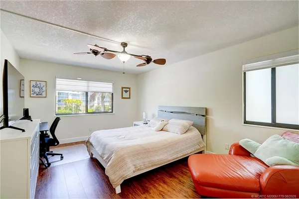 a bedroom with two beds and a desk