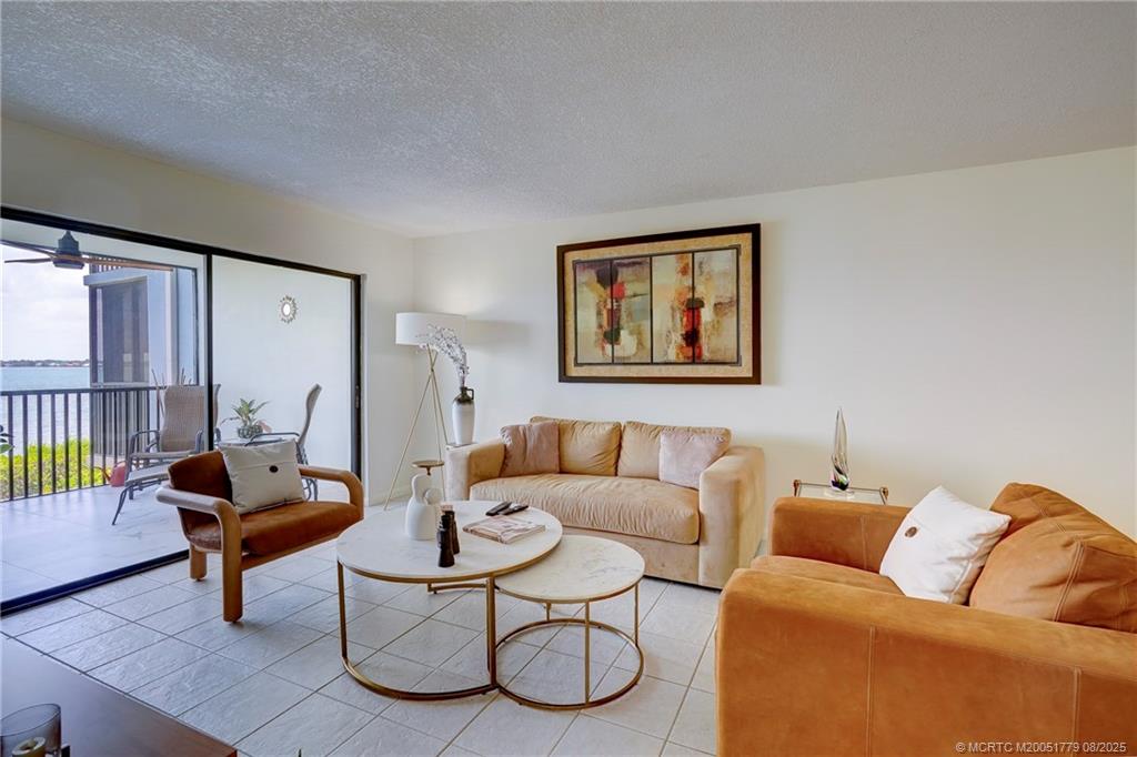 10 Northeast Plantation Road, Unit 101 Stuart, FL 34996 - Photo 22 of 36 a living room with furniture and wooden floor