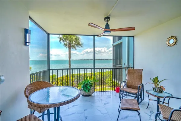 a balcony with table and chairs