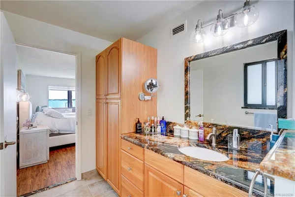 a en suite bathroom with a double vanity sink and a mirror