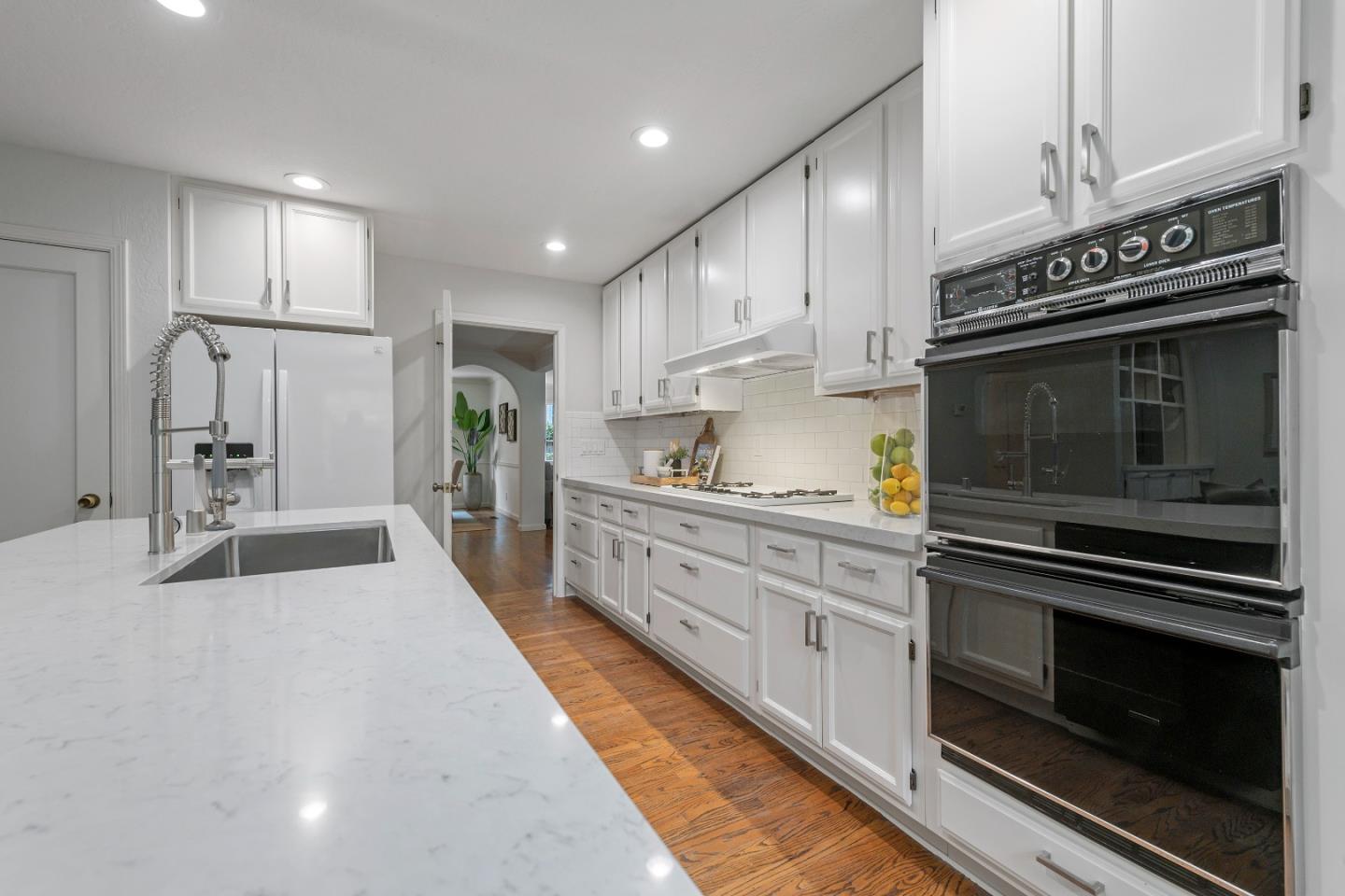 360 Iris Way Palo Alto, CA 94303 - Photo 11 of 28 a kitchen with stainless steel appliances kitchen island granite countertop a stove and a refrigerator
