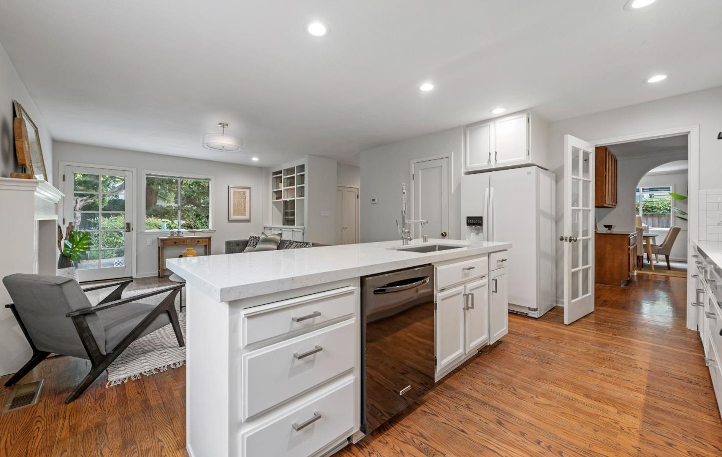 360 Iris Way Palo Alto, CA 94303 - Photo 12 of 28 a kitchen with stainless steel appliances kitchen island granite countertop a stove a refrigerator a dining table and chairs with wooden floor