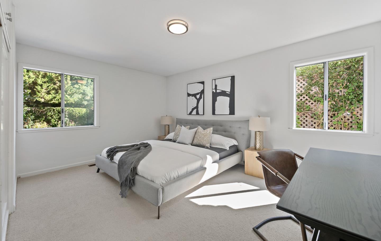 360 Iris Way Palo Alto, CA 94303 - Photo 19 of 28 a spacious bedroom with a bed and a couch next to a window