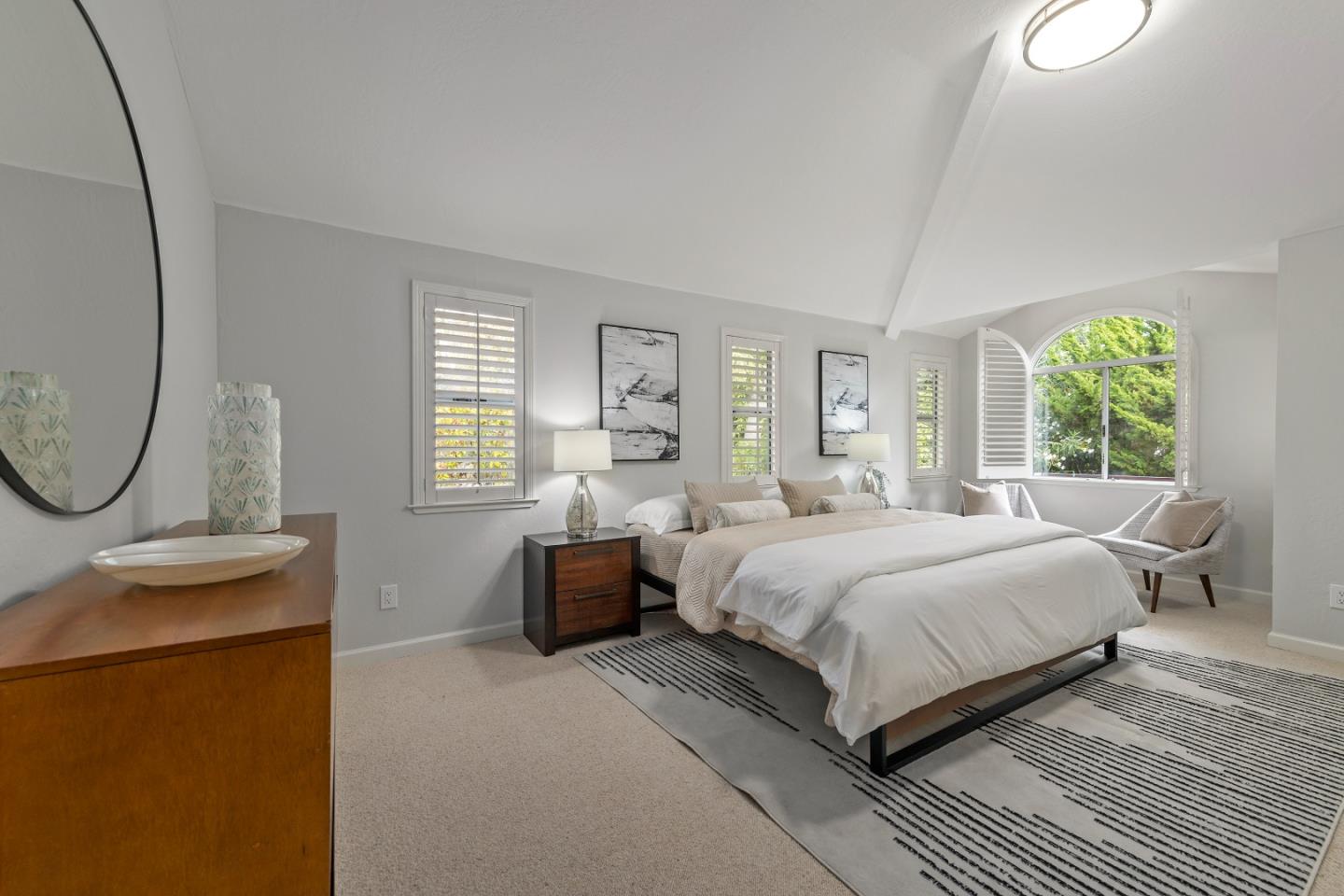 360 Iris Way Palo Alto, CA 94303 - Photo 21 of 28 a bedroom with a large bed and a chandelier