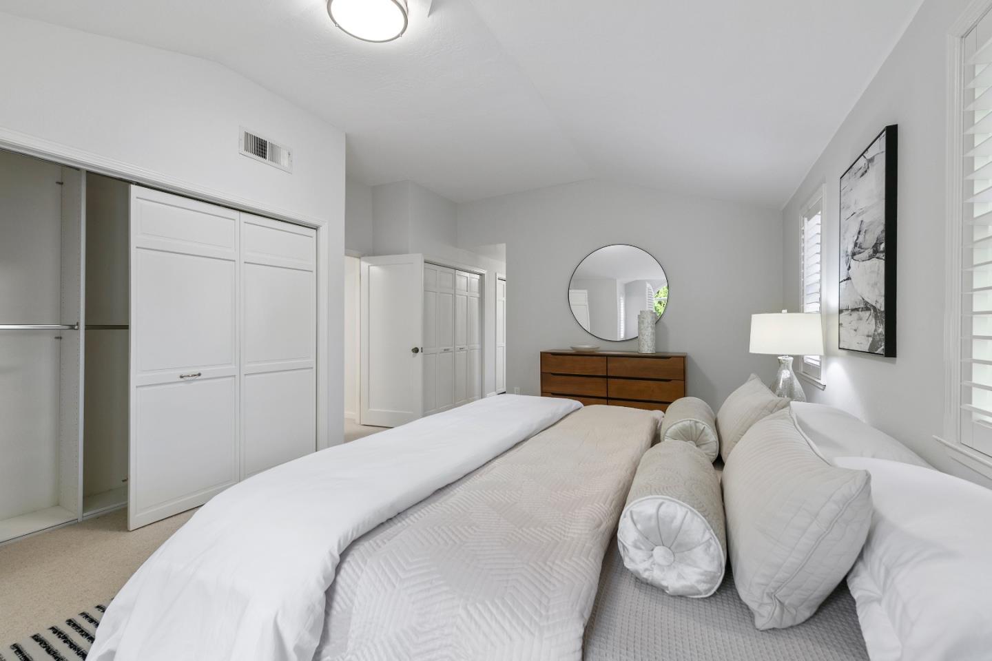 360 Iris Way Palo Alto, CA 94303 - Photo 22 of 28 a bedroom with a bed and a chandelier